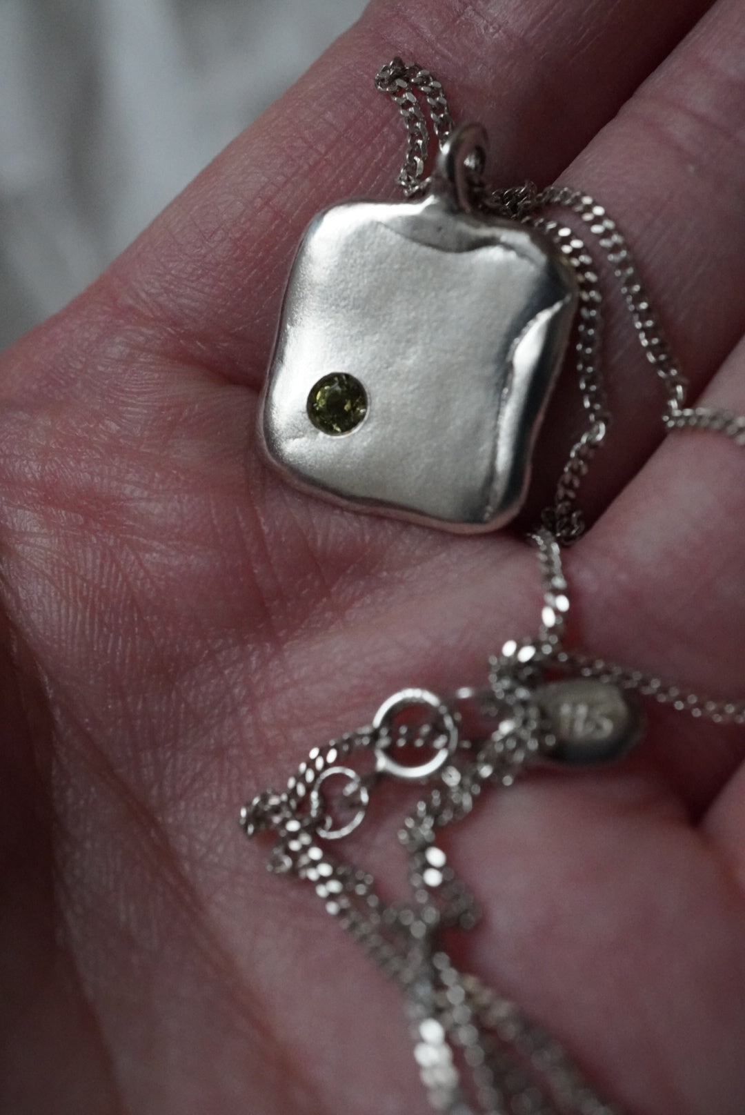Square nacklace with a stone