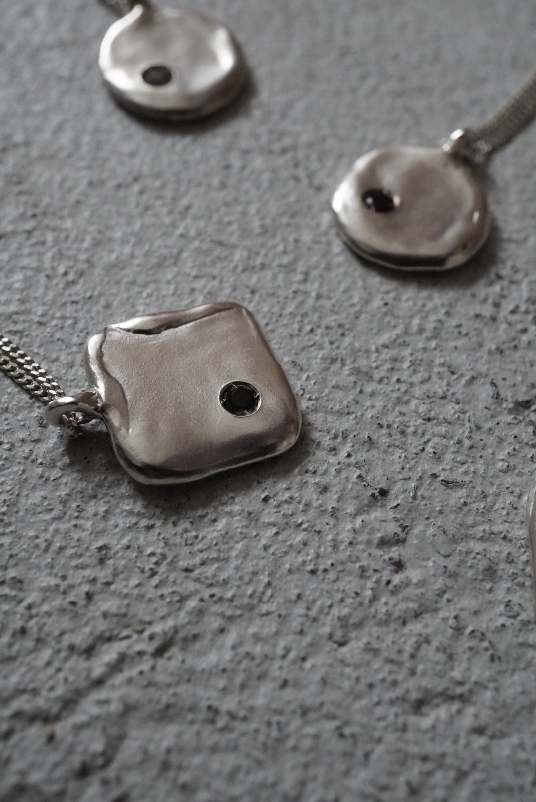 Square nacklace with a stone